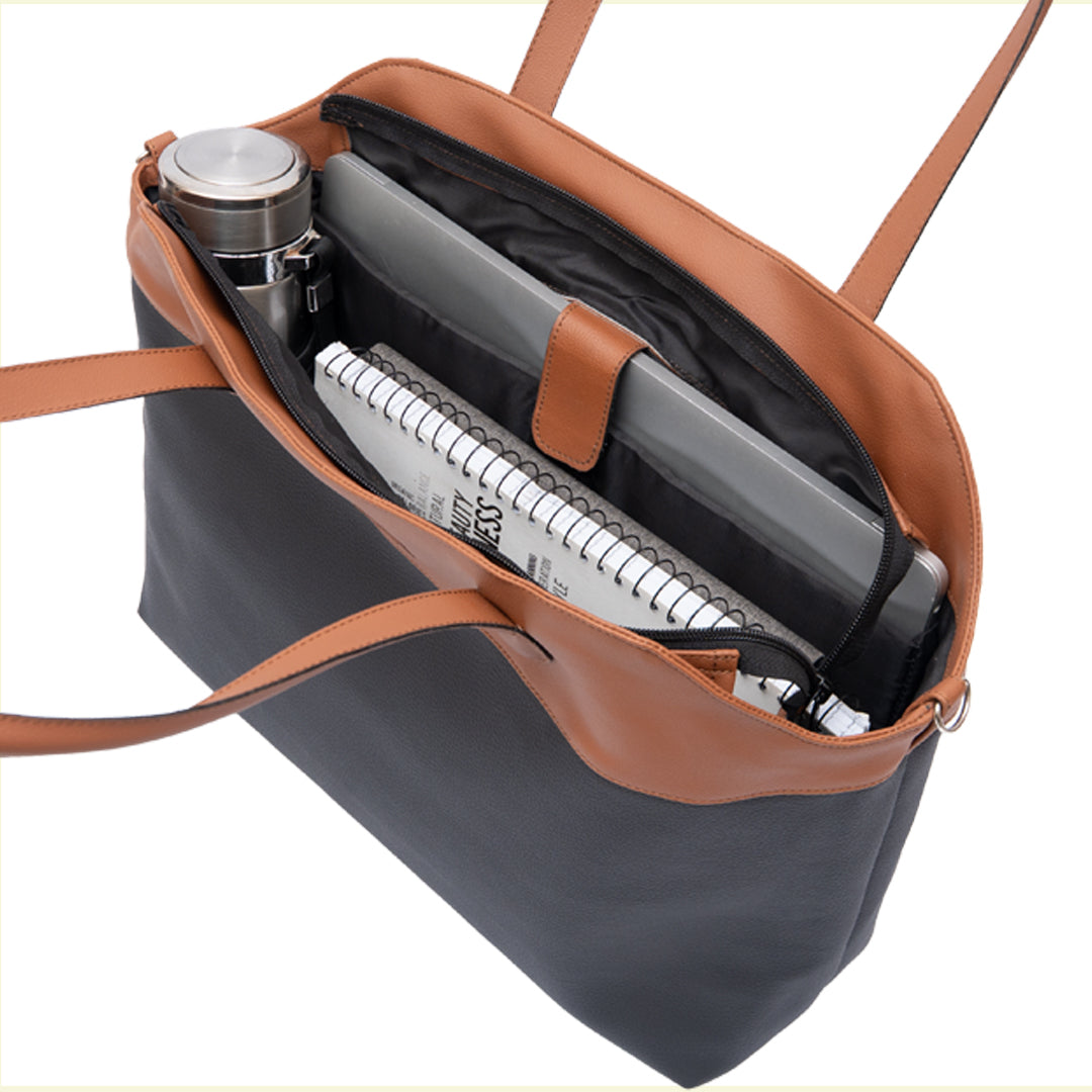 black and brown leather tote bag interior compartments laptop pocket and spacious interior