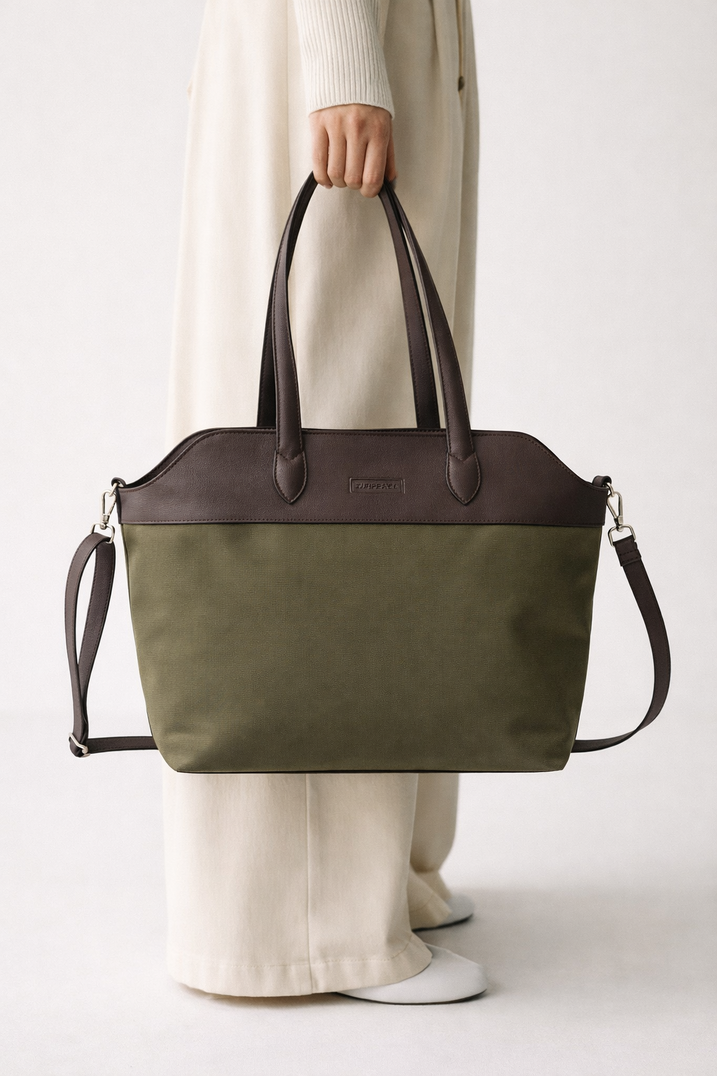woman carrying green tote bag